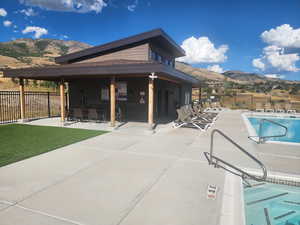 Community pool featuring a mountain view and a patio area