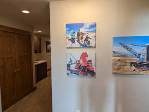 Hallway featuring carpet floors, recessed lighting, and a textured ceiling