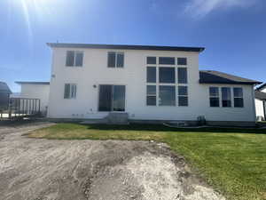 Rear view of house with a lawn