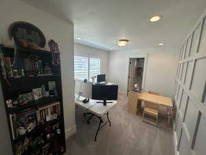 Carpeted bedroom featuring recessed lighting and a textured ceiling