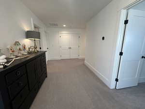 Corridor featuring light carpet and recessed lighting