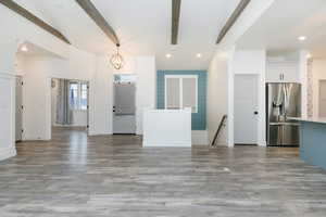 Living room featuring recessed lighting, beam ceiling, a chandelier, and dark wood-style floors