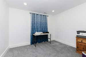 Carpeted bedroom with baseboards and recessed lighting