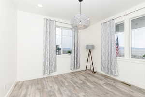 Flex room with light wood finished floors and baseboards