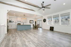 Living room with recessed lighting, light wood-style floors, and a ceiling fan