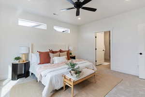 Bedroom featuring light carpet, recessed lighting, ceiling fan, and ensuite bath