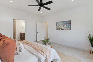 Bedroom featuring ensuite bathroom, carpet floors, recessed lighting, and a ceiling fan