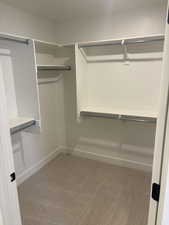 Photos are of staged model home.  Secondary Suite Walk in closet with light carpet