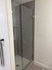 Photos are of staged model home. Secondary Suite Bathroom with a stall shower and a textured ceiling