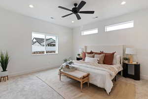 Bedroom with light carpet, multiple windows, ceiling fan, and recessed lighting