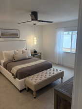 Photos are of staged model home. Carpeted Primary Suite Bedroom with a ceiling fan and baseboards