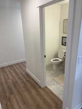 Photos are of staged model home. Hallway 1/2 Bathroom with light wood-type flooring and baseboards