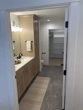 Photos are of staged model home.  Primary Suite Bathroom featuring vanity, a spacious closet, and a textured ceiling