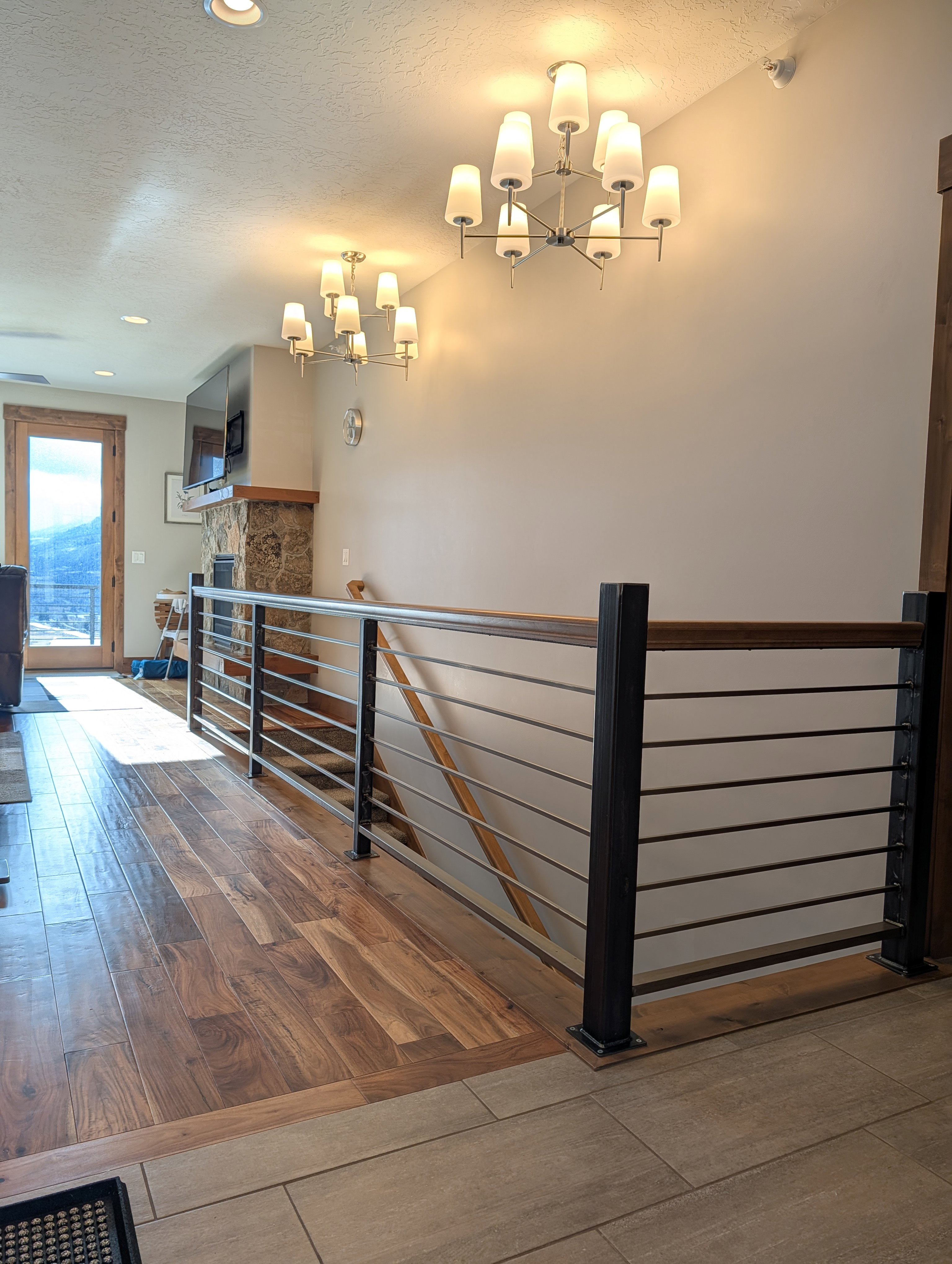Staircase featuring a textured ceiling, hardwood / wood-style floors, a fireplace, radiator, and recessed lighting