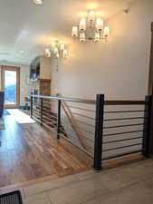 Staircase featuring a textured ceiling, hardwood / wood-style floors, a fireplace, radiator, and recessed lighting