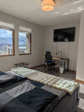 Bedroom with a desk and baseboards
