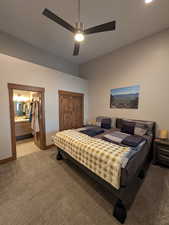 Bedroom featuring ceiling fan, carpet, and connected bathroom
