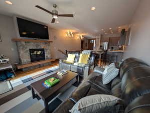 Living area featuring recessed lighting, a stone fireplace, wood finished floors, and ceiling fan