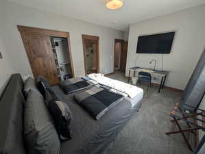 Bedroom featuring connected bathroom and carpet