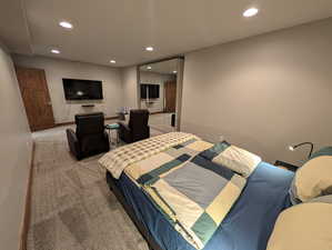 Carpeted bedroom with recessed lighting