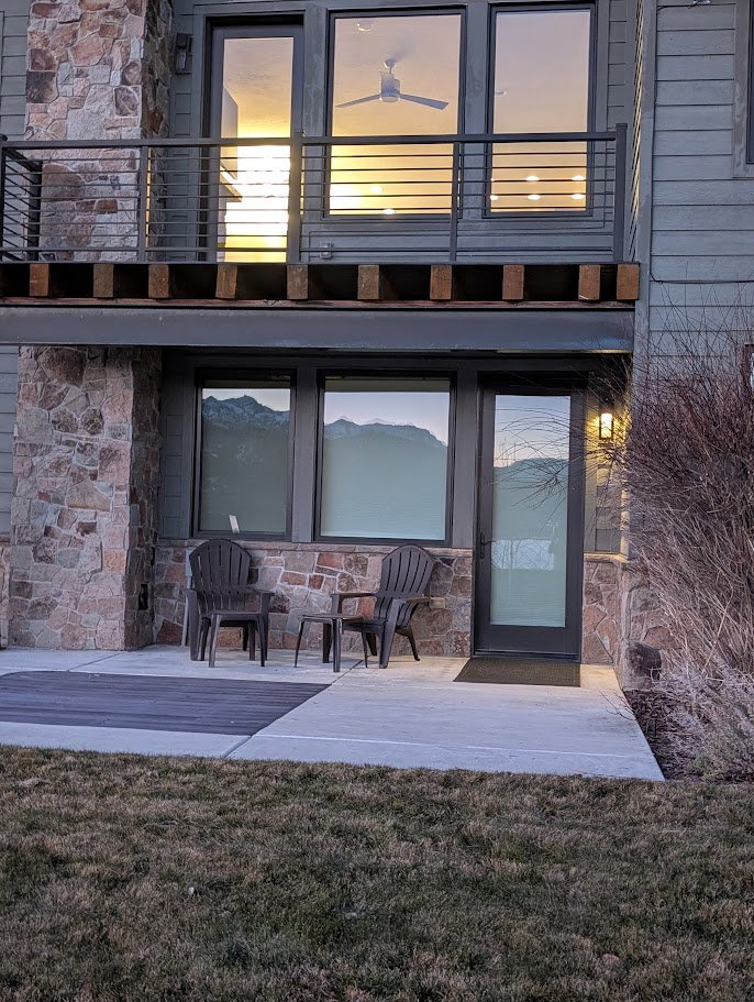 Entrance to property featuring stone siding