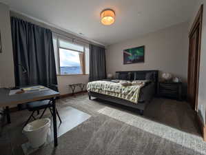Bedroom featuring carpet flooring and a desk
