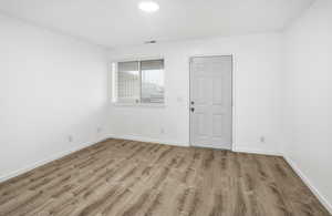 Empty room featuring wood finished floors and baseboards