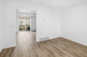 Unfurnished room with wood finished floors and baseboards