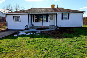 Ranch-style home featuring a chimney and roof with shingles