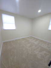 Spare room featuring light carpet and recessed lighting