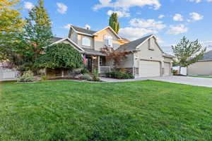 View of front facade with stucco siding, driveway, an attached garage, a porch, and a shingled roof