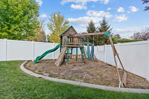 View of playground featuring a fenced backyard