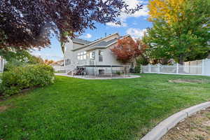 Rear view of house featuring a patio, a fenced backyard, and stairs
