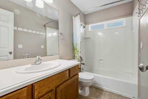 Bathroom featuring shower / bath combo, vanity, and light tile patterned floors