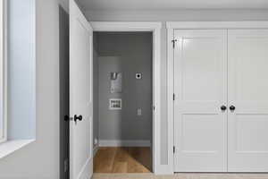 Hall with light wood finished floors