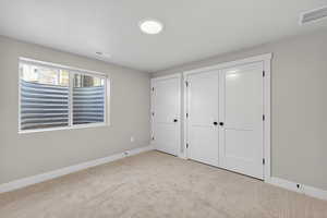 Unfurnished bedroom with carpet and a closet