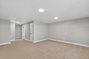 Below grade area featuring light carpet and recessed lighting