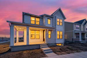 Modern home with covered porch and brick siding