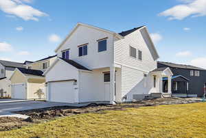 Traditional-style home with driveway and a front lawn