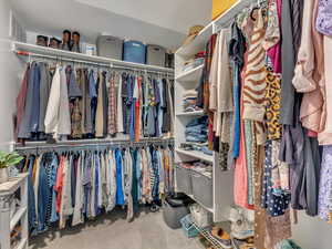 Walk in closet featuring light carpet