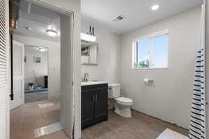 Bathroom featuring curtained shower and vanity