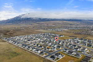 Aerial overview of property's location featuring nearby suburban area and mountains