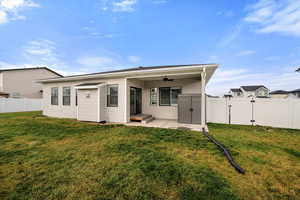 Rear view of property featuring a fenced backyard, ceiling fan, a patio area, and a gate