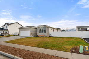 View of front of property featuring driveway, stucco siding, and an attached garage