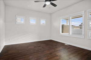 Spare room featuring dark wood-style flooring, ceiling fan, and recessed lighting