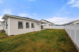 Back of property featuring a fenced backyard