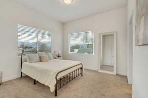 Bedroom featuring light colored carpet