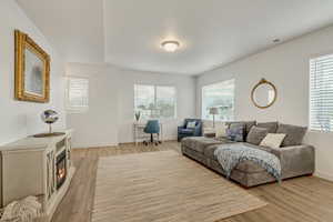 Living room featuring a desk, healthy amount of natural light, and light wood-style flooring