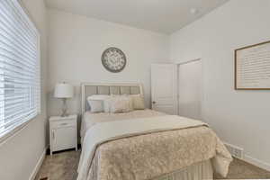 Carpeted bedroom with baseboards