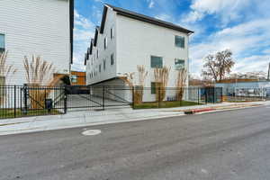 View of front facade with a fenced front yard and a gate